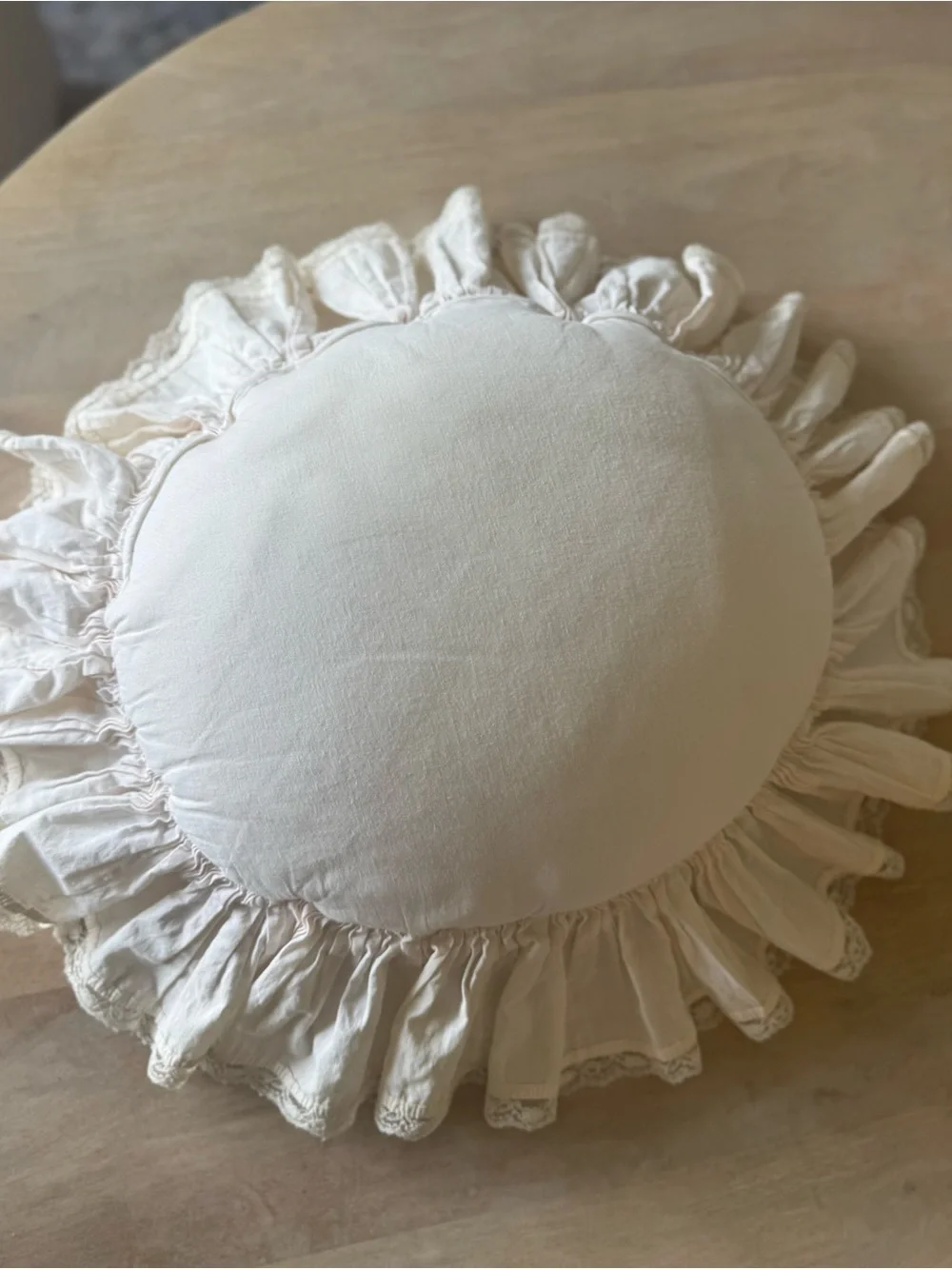 Handmade white candlewicking starburst pillow with ruffled lace trim.